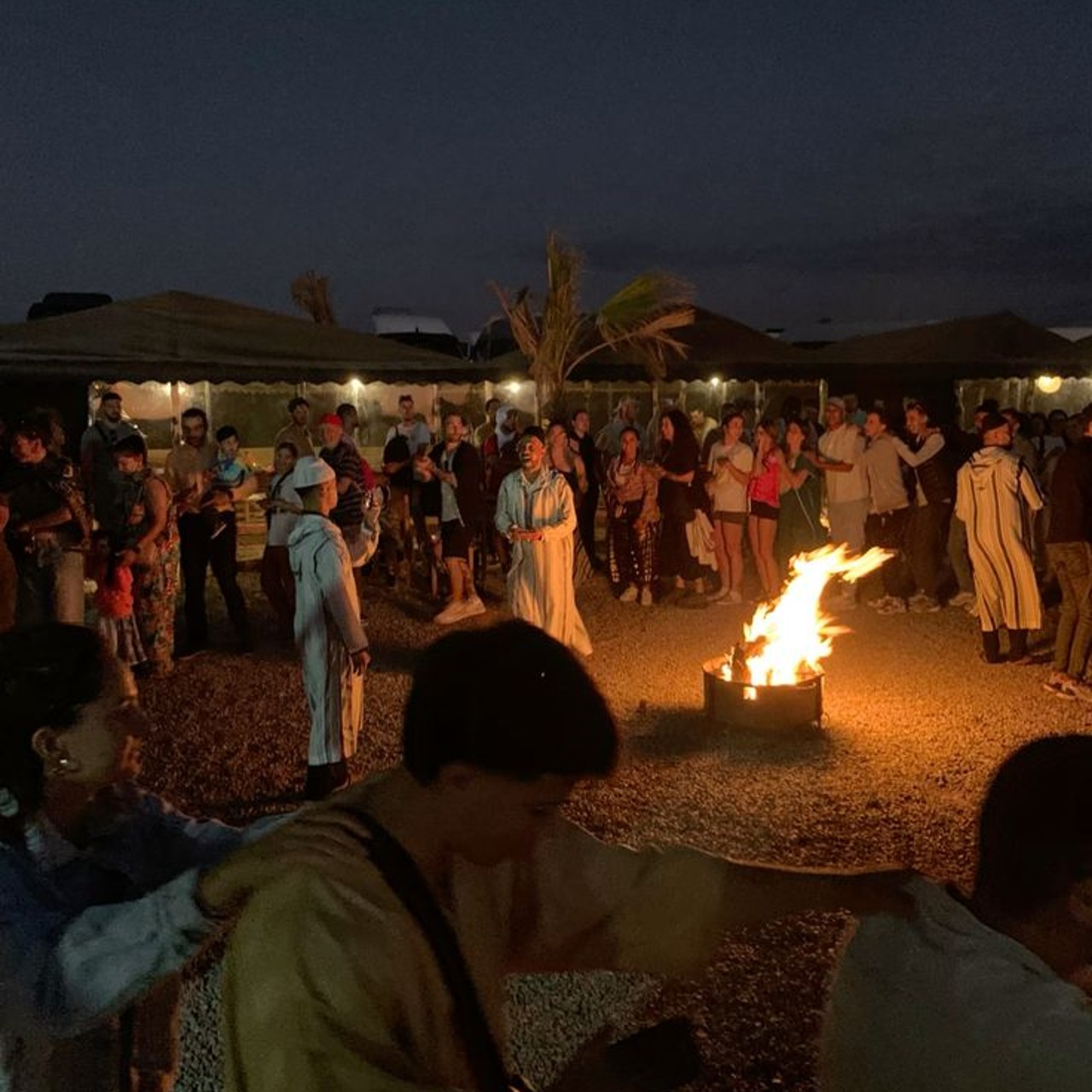 Evening Moroccan music and fire show around a bonfire at an Agafay desert camp